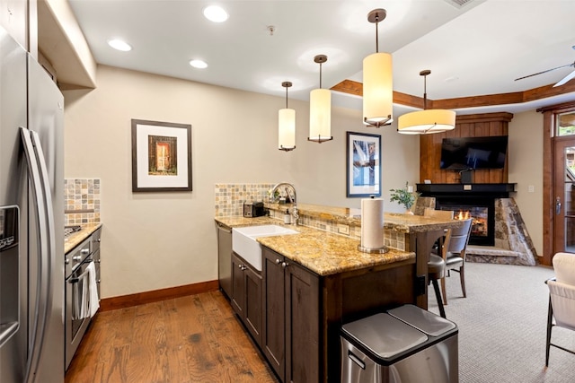 1521 Ski Hill Rd Unit 8313, Breckenridge, CO 80424 - kitchen with stainless steel appliances, a peninsula, a breakfast bar, backsplash, and recessed lighting