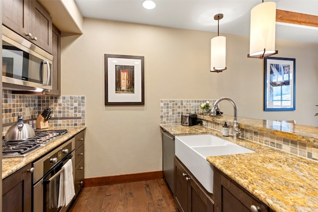 1521 Ski Hill Rd Unit 8313, Breckenridge, CO 80424 - kitchen with stainless steel appliances, dark wood finished floors, dark brown cabinetry, backsplash, and light stone countertops