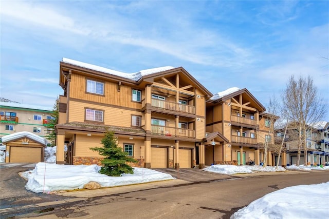 3335 Columbine Dr Unit 907, Steamboat Springs, CO 80487 - snow covered building featuring driveway and a garage