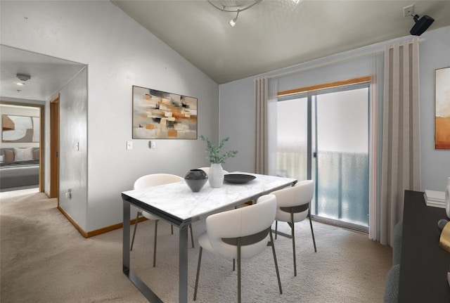 3335 Columbine Dr Unit 907, Steamboat Springs, CO 80487 - dining space with vaulted ceiling, baseboards, and light colored carpet