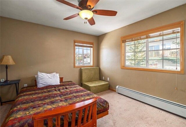 3335 Columbine Dr Unit 907, Steamboat Springs, CO 80487 - bedroom featuring a baseboard heating unit, carpet flooring, baseboards, and ceiling fan
