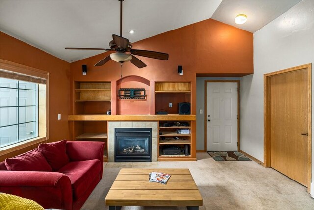 3335 Columbine Dr Unit 907, Steamboat Springs, CO 80487 - carpeted living area featuring a tiled fireplace, a ceiling fan, baseboards, and built in shelves