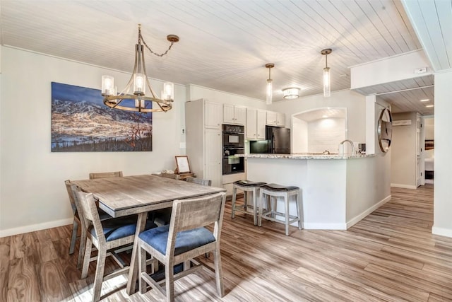 2286 Apres Ski Way Unit 105, Steamboat Springs, CO 80477 - dining room with a chandelier, wooden ceiling, baseboards, and light wood-type flooring