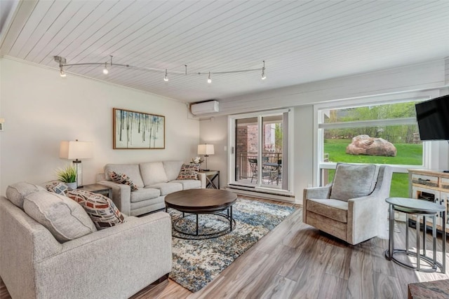 2286 Apres Ski Way Unit 105, Steamboat Springs, CO 80477 - living area featuring a wall mounted air conditioner, plenty of natural light, wood finished floors, and wooden ceiling