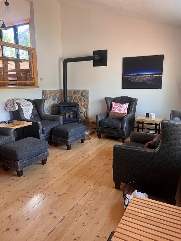 3 Miners Creek Rd, Frisco, CO 80443 - living area with vaulted ceiling, light wood finished floors, and a wood stove