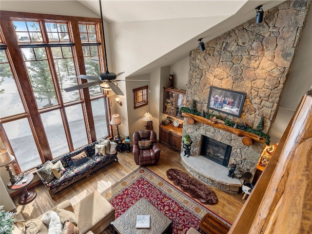 585 Independence Rd, Keystone, CO 80435 - living area with lofted ceiling, a fireplace, wood finished floors, and a ceiling fan