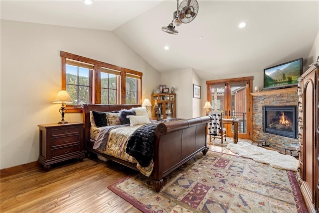 585 Independence Rd, Keystone, CO 80435 - bedroom featuring recessed lighting, lofted ceiling, light wood finished floors, access to exterior, and a fireplace