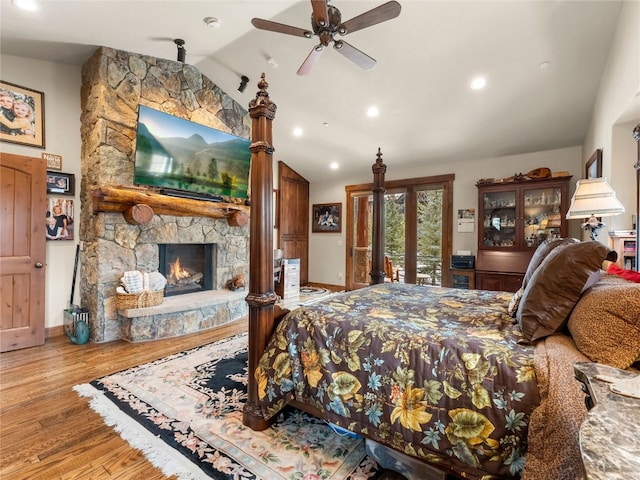 585 Independence Rd, Keystone, CO 80435 - bedroom with vaulted ceiling, wood finished floors, baseboards, access to exterior, and a stone fireplace