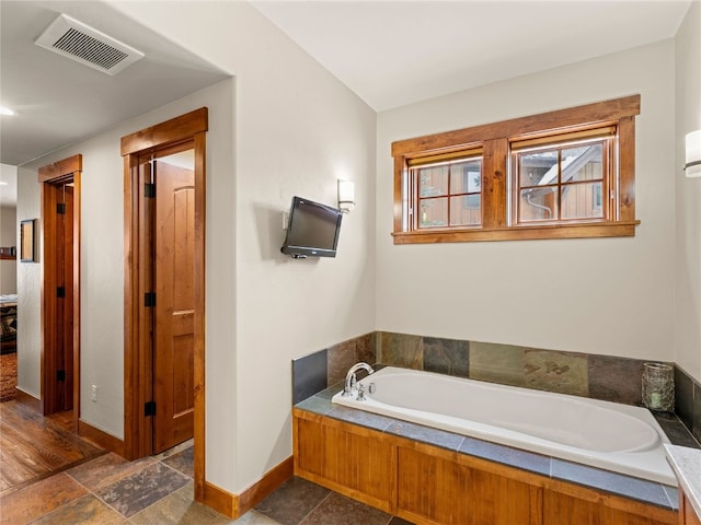 585 Independence Rd, Keystone, CO 80435 - full bath with a bath, baseboards, stone finish floor, and visible vents