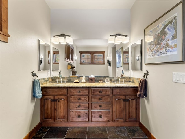 585 Independence Rd, Keystone, CO 80435 - bathroom featuring double vanity, baseboards, and stone finish flooring