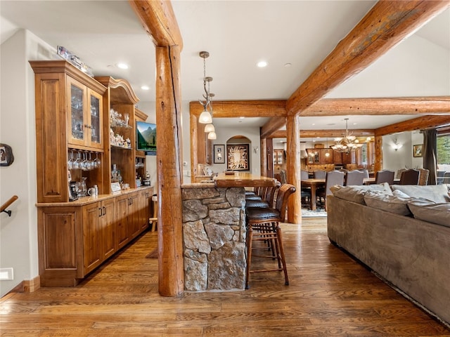 585 Independence Rd, Keystone, CO 80435 - bar featuring beamed ceiling, a chandelier, wood finished floors, and hanging light fixtures