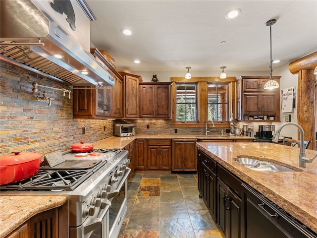 585 Independence Rd, Keystone, CO 80435 - kitchen with under cabinet range hood, high end range, a sink, stone tile flooring, and recessed lighting