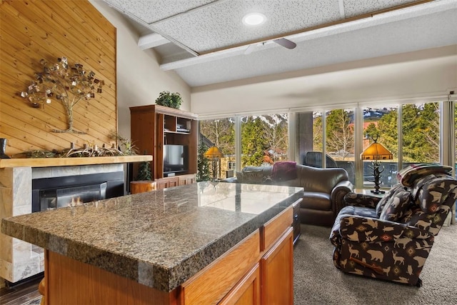 705 Snowberry Ln Unit 303, Breckenridge, CO 80424 - kitchen featuring open floor plan, healthy amount of natural light, a glass covered fireplace, beam ceiling, and recessed lighting