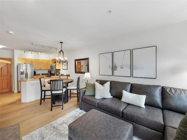 140 Ida Belle Dr Unit 8153, Keystone, CO 80435 - living area featuring light wood-style floors and a chandelier