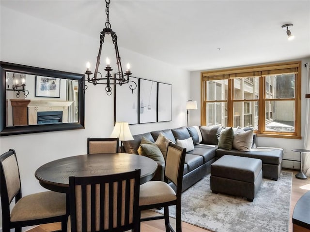 140 Ida Belle Dr Unit 8153, Keystone, CO 80435 - living area featuring wood finished floors, a chandelier, and a baseboard radiator