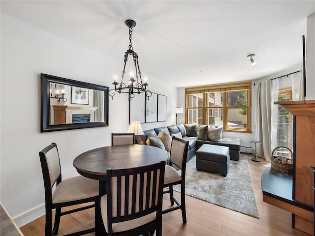 140 Ida Belle Dr Unit 8153, Keystone, CO 80435 - dining area with light wood-style floors, a chandelier, and baseboard heating