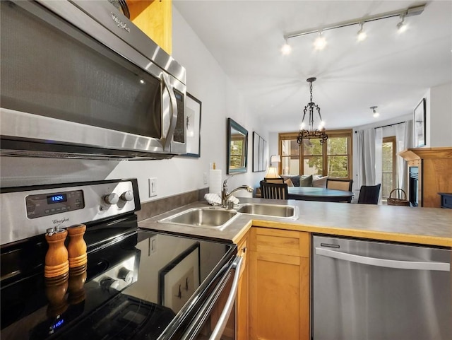 140 Ida Belle Dr Unit 8153, Keystone, CO 80435 - kitchen featuring appliances with stainless steel finishes, a chandelier, track lighting, decorative light fixtures, and a peninsula