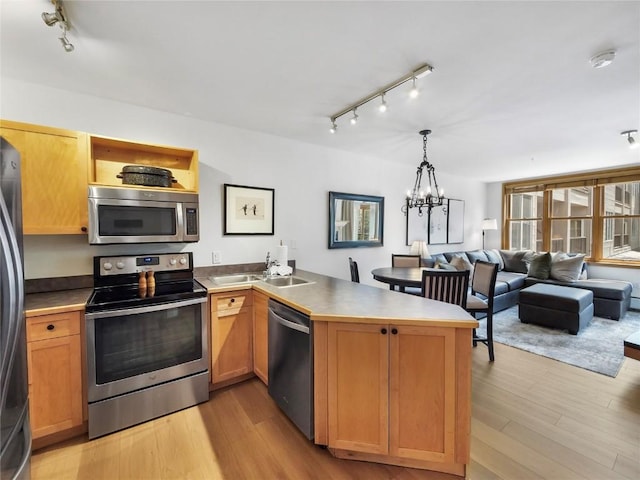 140 Ida Belle Dr Unit 8153, Keystone, CO 80435 - kitchen featuring appliances with stainless steel finishes, track lighting, a peninsula, and light wood finished floors