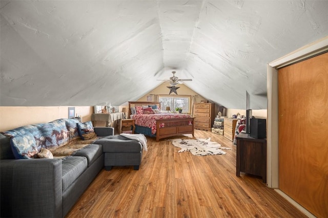 bedroom with lofted ceiling and wood finished floors