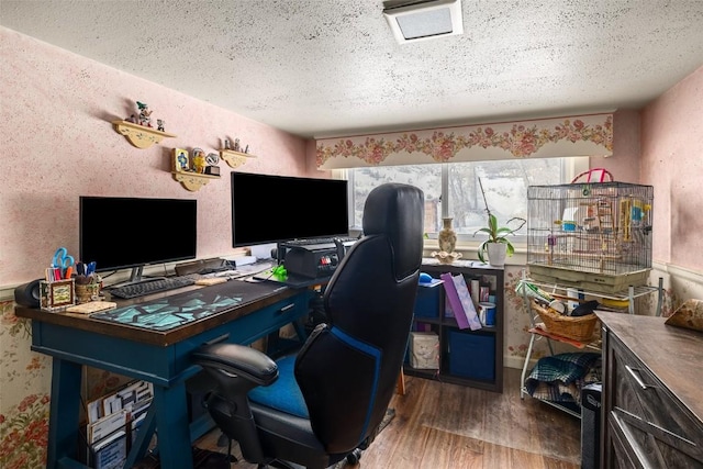 home office with a textured ceiling and wood finished floors