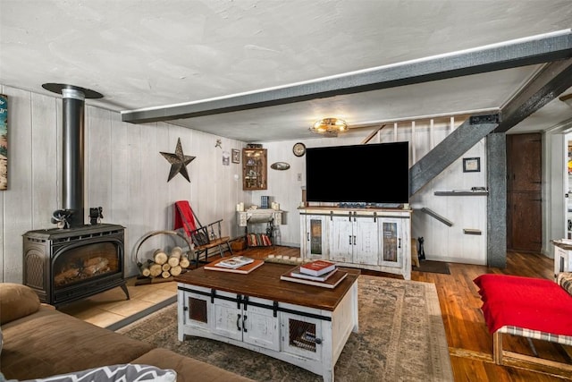 living area featuring a wood stove and wood finished floors