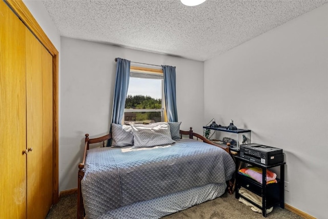 27100 Neptune Pl, Clark, CO 80428 - carpeted bedroom featuring baseboards and a textured ceiling