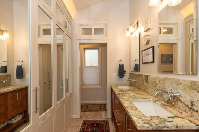 102 S High St, Breckenridge, CO 80424 - bathroom featuring double vanity and lofted ceiling