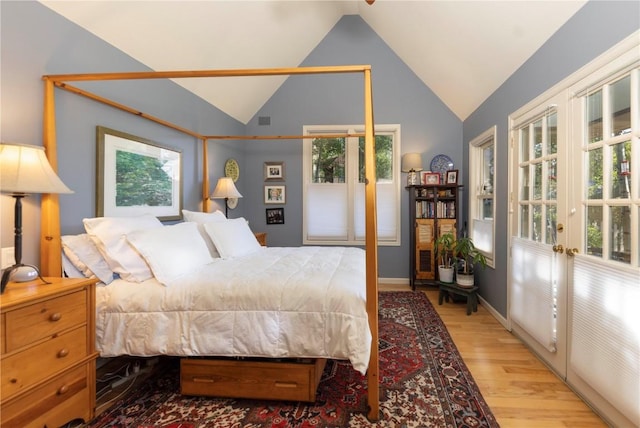 102 S High St, Breckenridge, CO 80424 - bedroom with french doors, wood finished floors, multiple windows, vaulted ceiling, and baseboards
