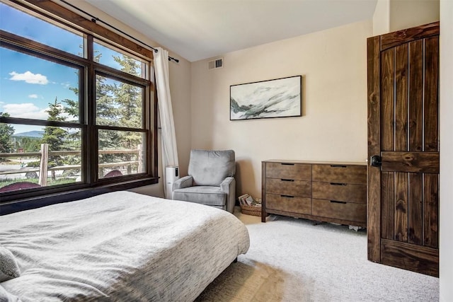 bedroom with visible vents and light colored carpet