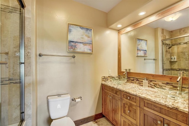 full bathroom with toilet, a stall shower, vanity, baseboards, and recessed lighting