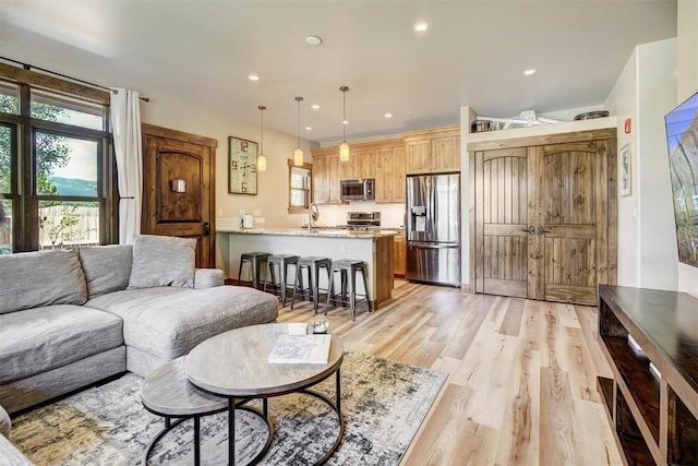 living area featuring recessed lighting and light wood-style floors