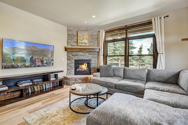 living room featuring wood finished floors, a fireplace, and recessed lighting