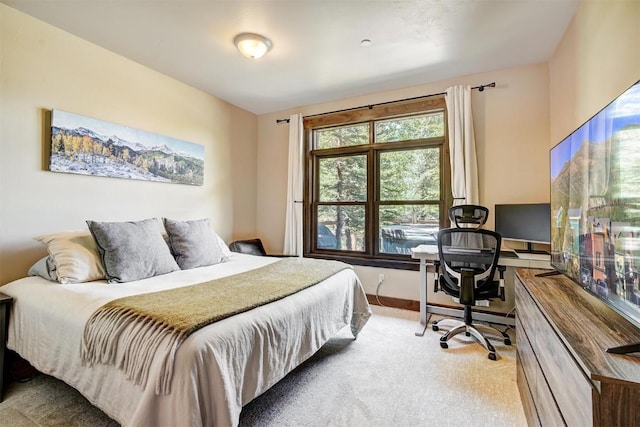 bedroom with baseboards and carpet