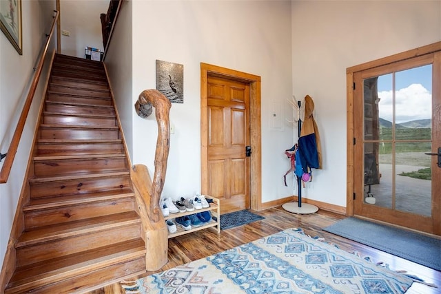 26755 Aspen Ct, Clark, CO 80428 - entryway featuring stairs, wood finished floors, baseboards, a high ceiling, and a mountain view