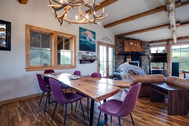 26755 Aspen Ct, Clark, CO 80428 - dining area featuring wood finished floors, baseboards, a chandelier, and a stone fireplace