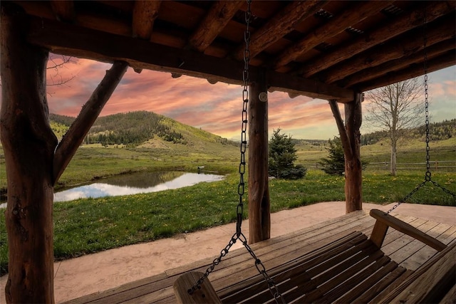 26755 Aspen Ct, Clark, CO 80428 - deck at dusk featuring a water and mountain view and a lawn