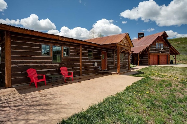 26755 Aspen Ct, Clark, CO 80428 - view of front of home featuring metal roof, a garage, and an outbuilding