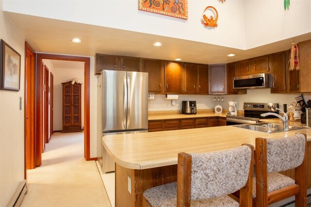 324 W Main St Unit 324, Frisco, CO 80443 - kitchen with appliances with stainless steel finishes, baseboard heating, light countertops, a peninsula, and a sink