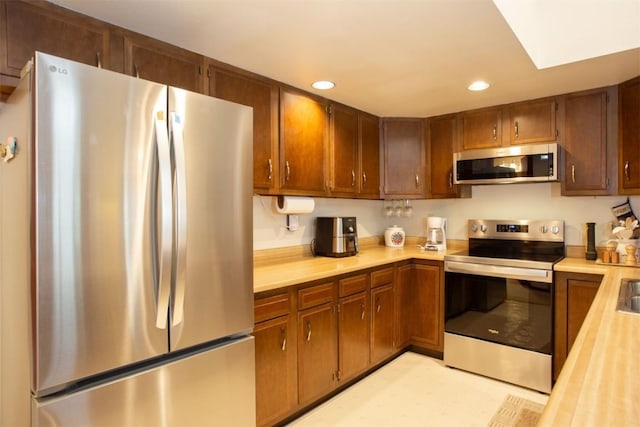 324 W Main St Unit 324, Frisco, CO 80443 - kitchen featuring stainless steel appliances, light countertops, recessed lighting, and brown cabinets