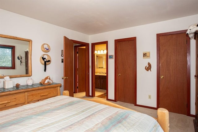 324 W Main St Unit 324, Frisco, CO 80443 - bedroom featuring light carpet, ensuite bath, a sink, two closets, and baseboards