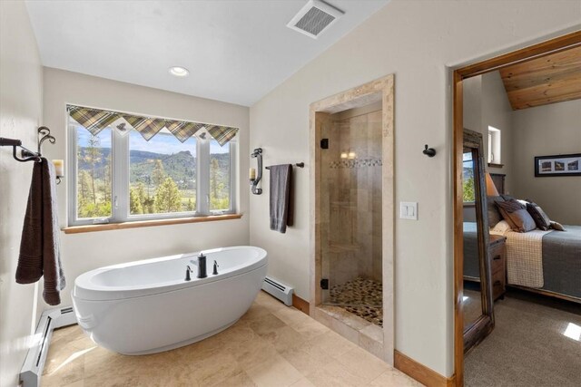 bathroom featuring visible vents, baseboard heating, lofted ceiling, and ensuite bath