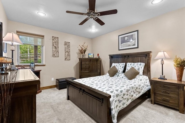 bedroom with baseboards, recessed lighting, and light carpet
