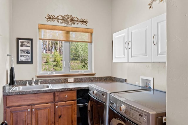 laundry area featuring a sink, cabinet space, and washer and clothes dryer