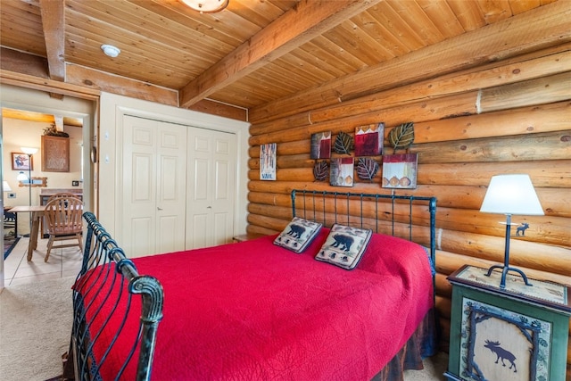 100 Cove Blvd Unit F, Dillon, CO 80435 - bedroom with wood ceiling with exposed beams, log walls, a closet, and tile patterned flooring