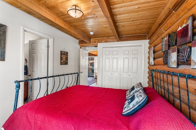 100 Cove Blvd Unit F, Dillon, CO 80435 - bedroom with rustic walls, wood ceiling with exposed beams, and a closet