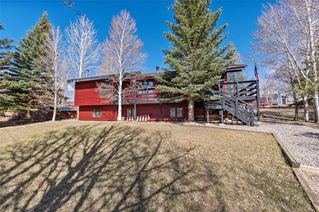 314 17th St, Kremmling, CO 80459 - rear view of property with a yard, stairway, and a deck
