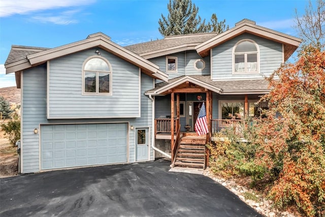 view of front of house featuring covered porch and a garage