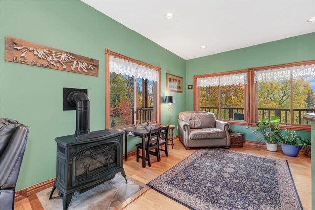 sitting room with light hardwood / wood-style flooring and a wood stove