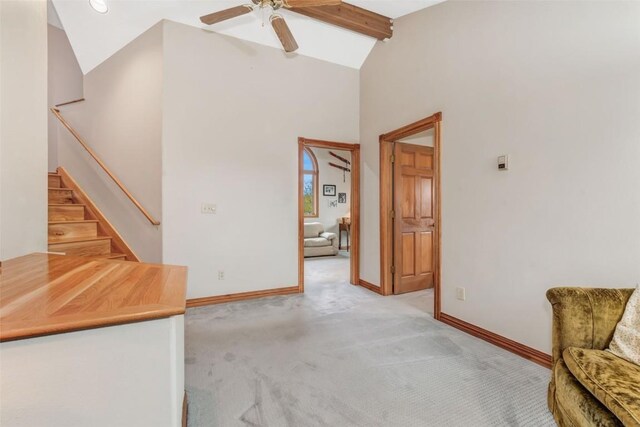 interior space featuring ceiling fan, beam ceiling, and high vaulted ceiling