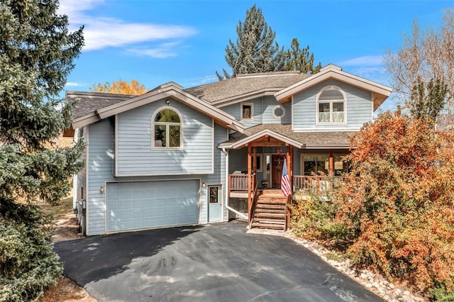 view of front of home featuring a porch and a garage